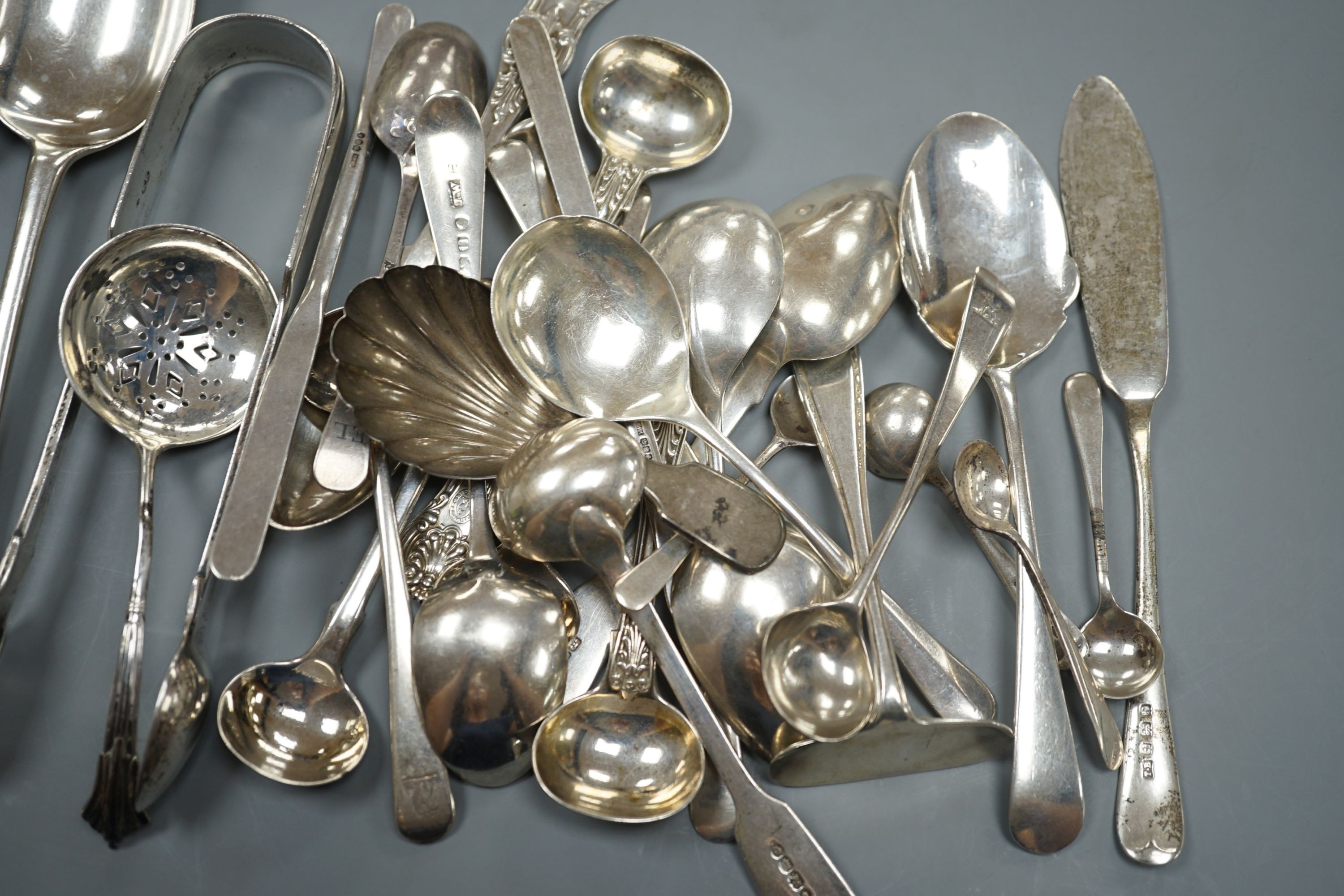 A quantity of assorted mainly 19th century and later flatware, including two Georgian caddy spoons, Victorian tablespoons, an 18th century tablespoon and assorted condiment spoons, various dates and maker's
